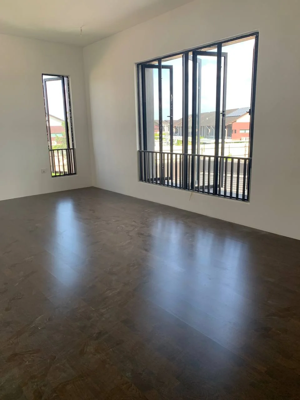 Hevea, City of Elmina — three-strip engineered white oak · walnut stain, original project photograph 1